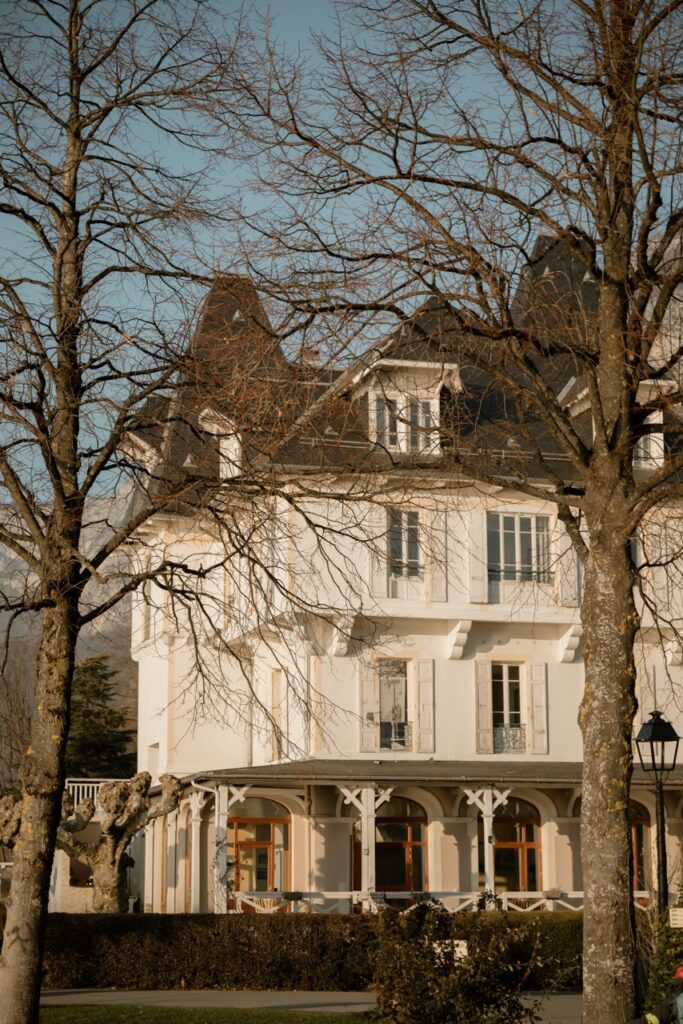 Exterior of La Croix des Champs wedding venue in winter, bare trees and warm light
