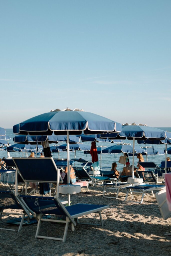 Blue beach umbrellas at sunset, Italian Riviera wedding venue Liguria