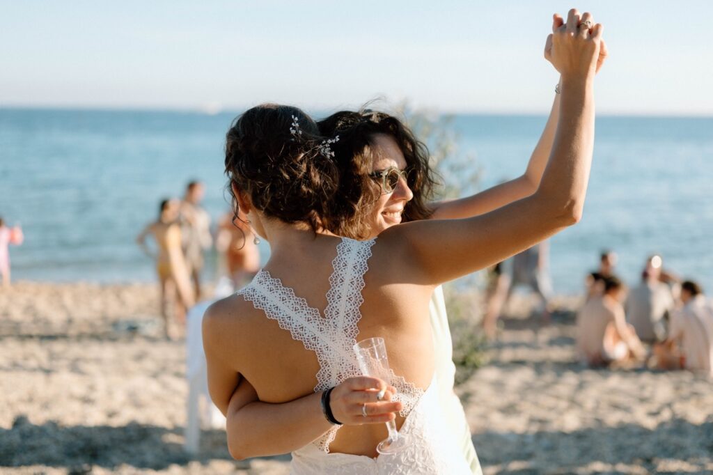 ride dancing with friend at golden hour, beach wedding Finale Ligure