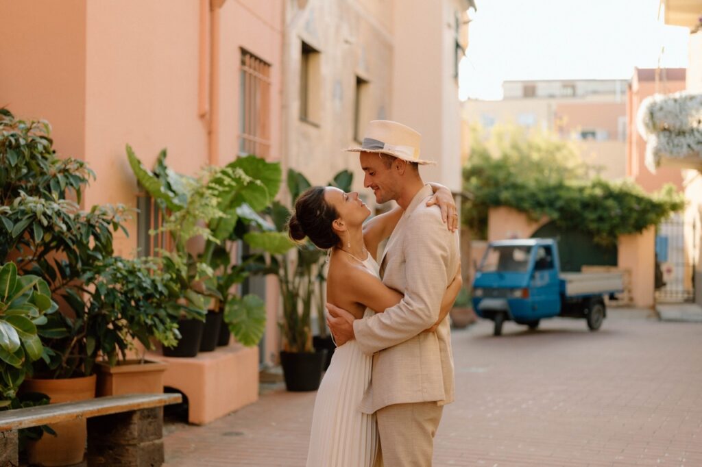 Couple embracing in Finalborgo street, destination wedding Finale Ligure Italy
