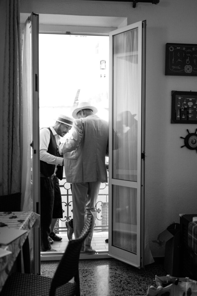 Groom getting ready with friend, documentary wedding photography Italy